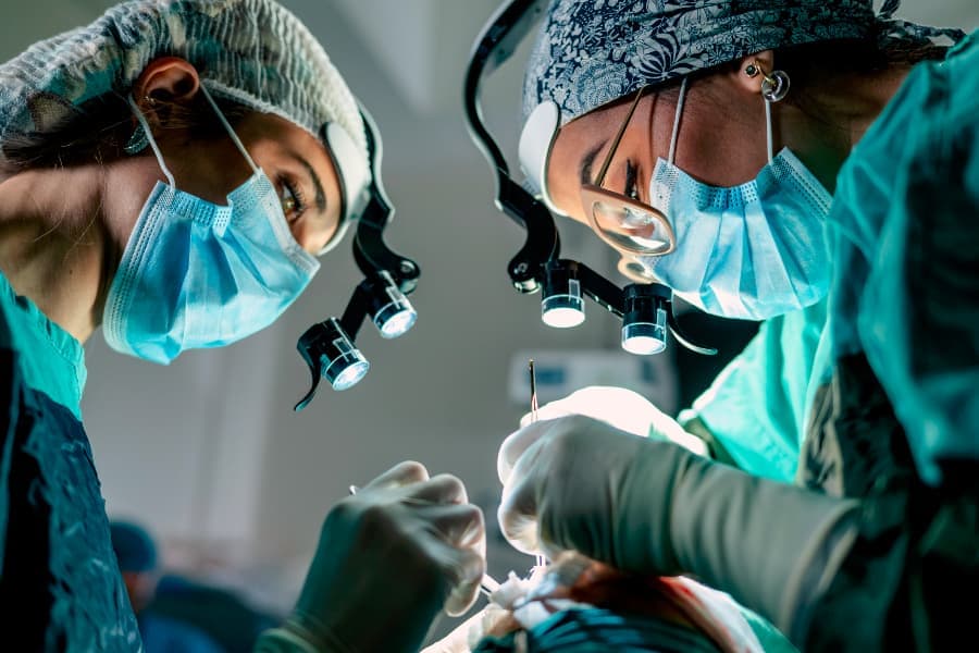 Two surgeons performing surgery in operating room 