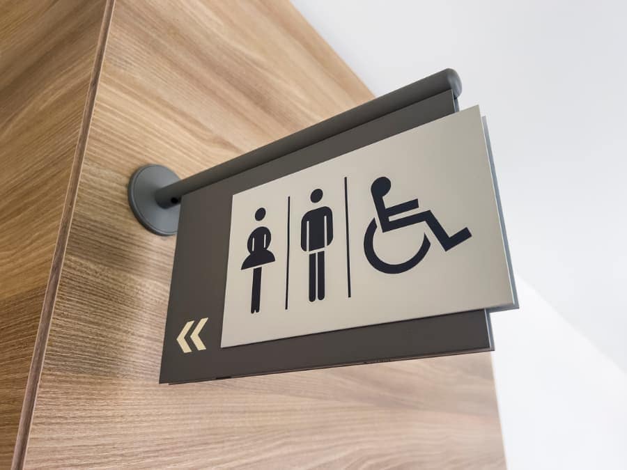 Restroom sign indicating way to bathroom