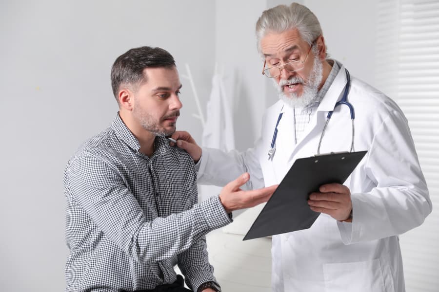 Male patient speaking with urologist about Peyronie’s disease symptoms