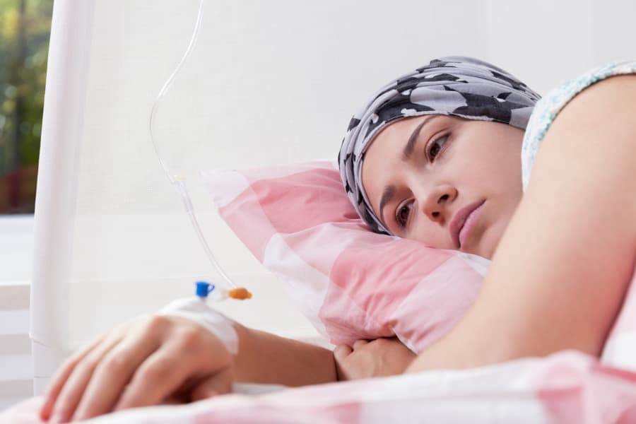 Patient with cancer receiving treatment and looking exhausted