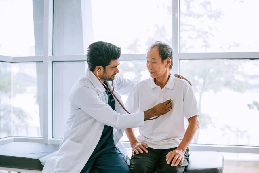 Doctor examining a patient with a stethoscope during a consultation in a hospital