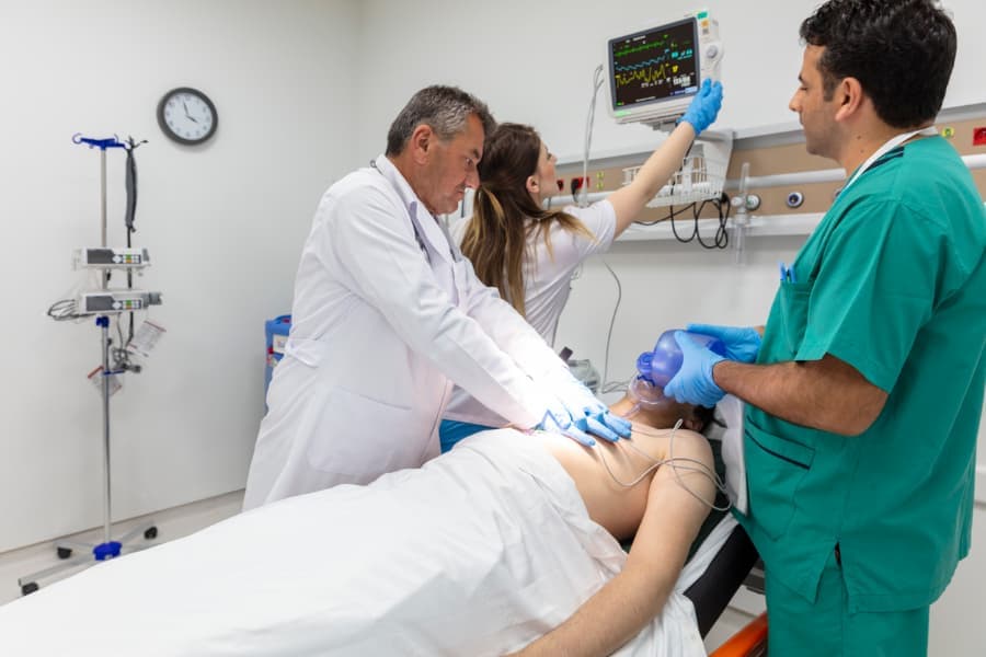 Physicians giving first aid to patient who had heart attack