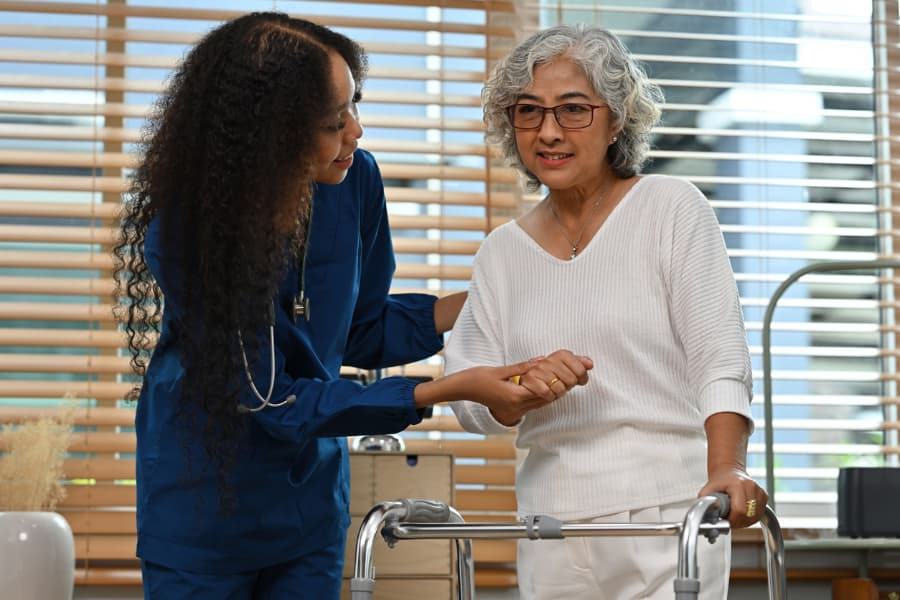 Physical therapy nurse assisting stroke patient