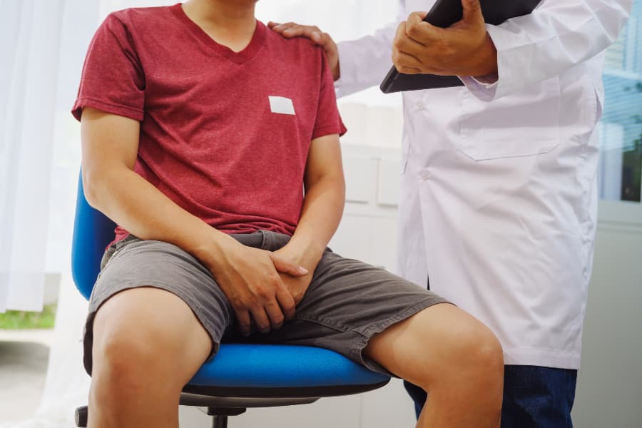 Patient discussing symptoms of enlarged prostate with physician