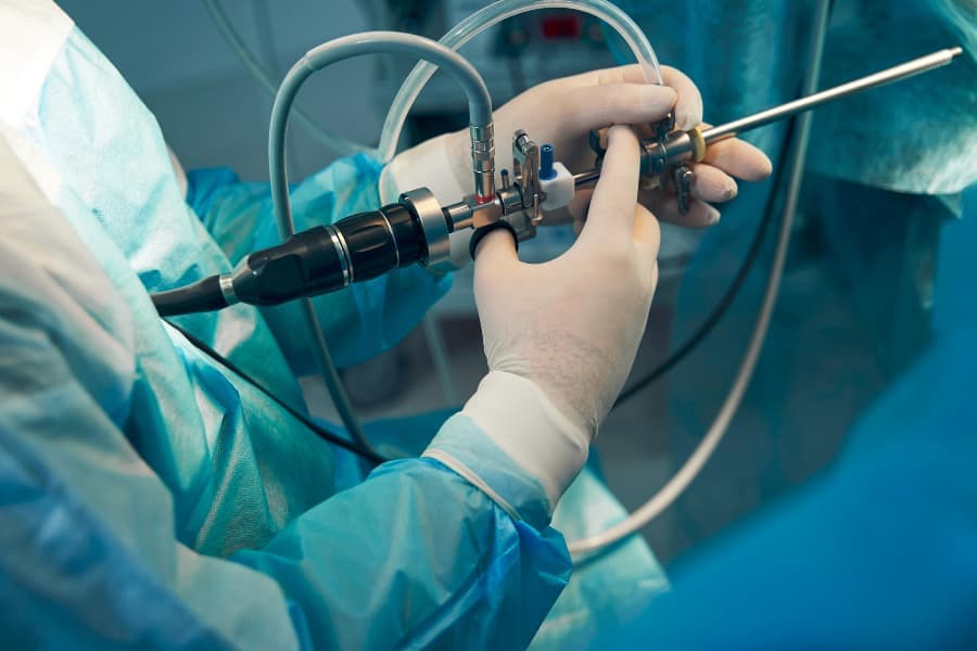 Physician holding thin light tube used for hysteroscopy 
