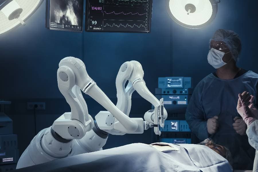 Two surgeons in operating room with robot arms operating on patient