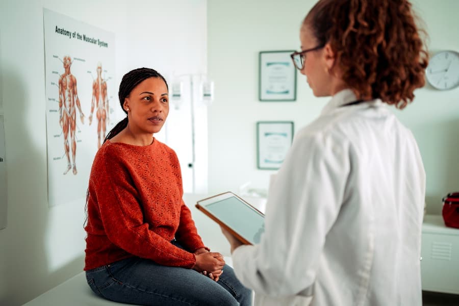 Woman patient discussing treatment with physician