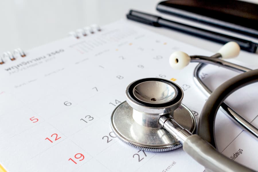 Annual checkup concept with stethoscope on calendar